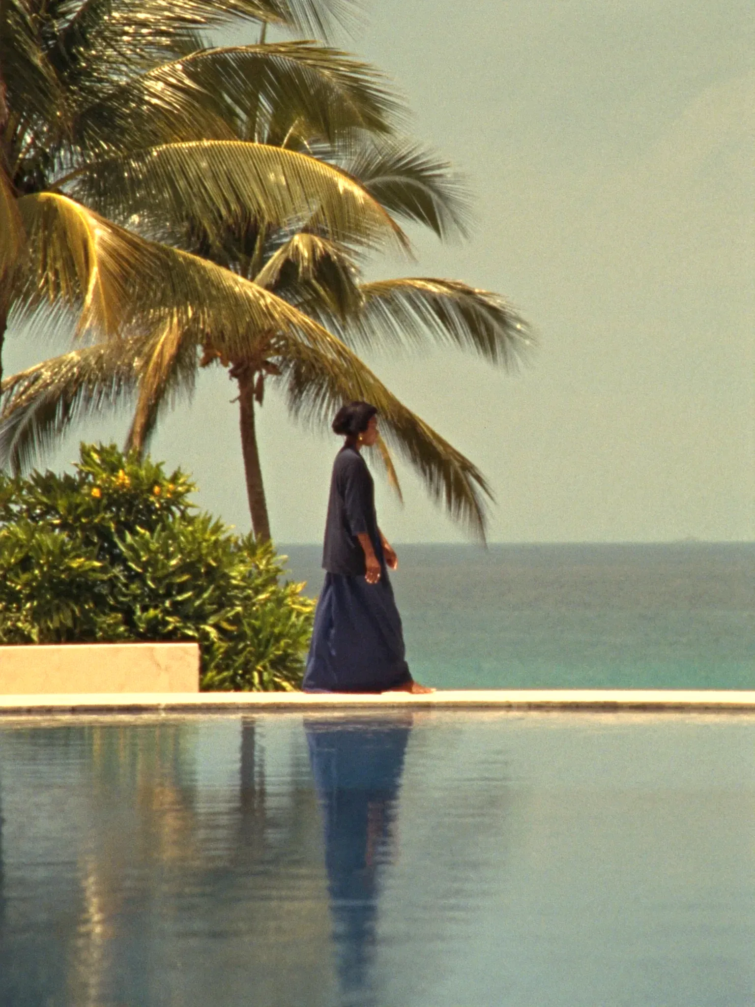 A guest walking calmly by the pool (placeholder)
